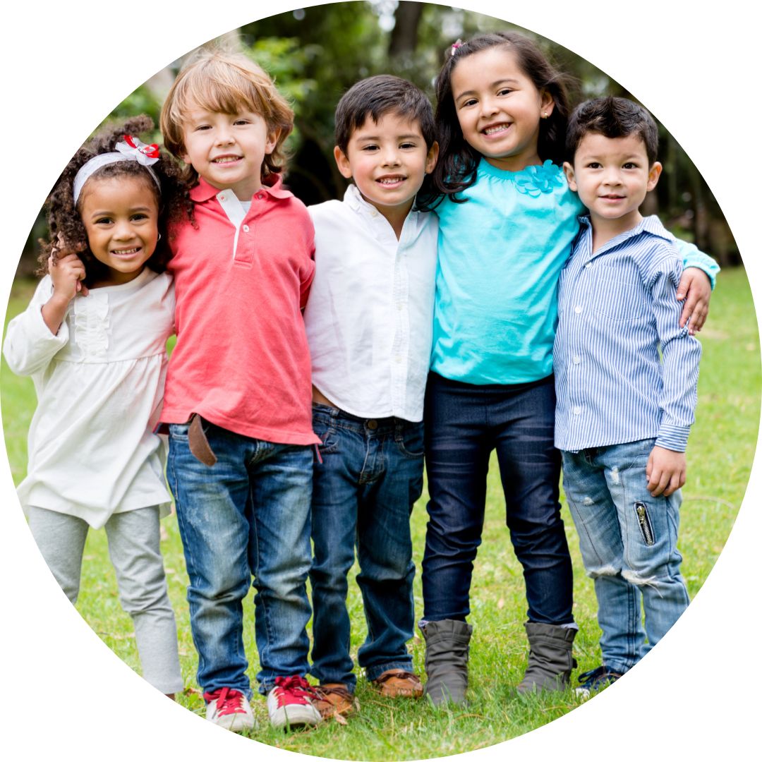 A group of five small kids outside.
